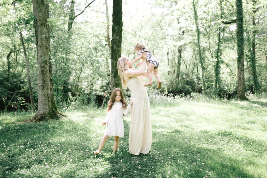 WHAT MOMS REALLY WANT FOR MOTHER'S DAY || AN HONEST MOTHER'S DAY GIFT GUIDE | What Moms Really Want for Mother's Day by popular Nashville lifestyle blog, Nashville Wifestyles: image of a mom and her two daughters wearing cream dresses and standing in a meadow. 