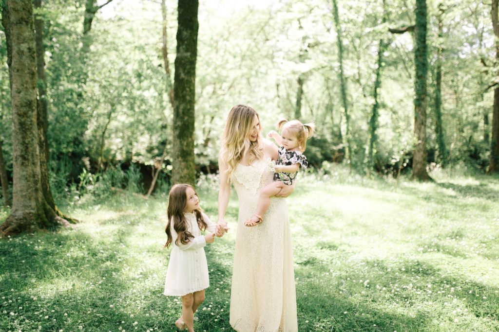 WHAT MOMS REALLY WANT FOR MOTHER'S DAY || AN HONEST MOTHER'S DAY GIFT GUIDE | What Moms Really Want for Mother's Day by popular Nashville lifestyle blog, Nashville Wifestyles: image of a mom and her two daughters wearing cream dresses and standing in a meadow. 