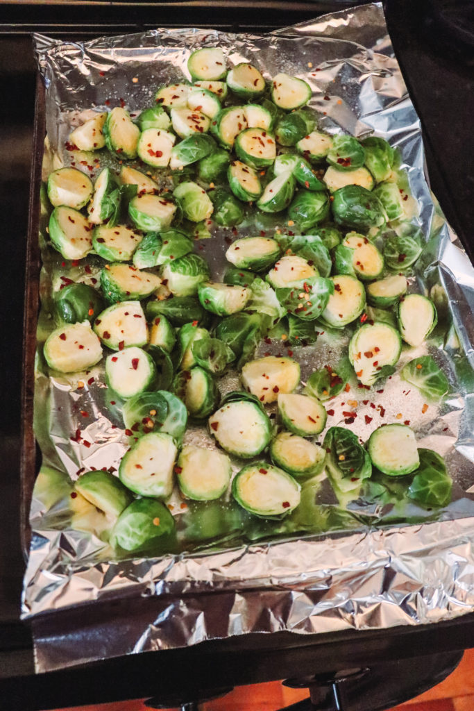 Honey Roasted Brussel Sprouts by popular Nashville life and style blog, Nashville Wifestyles: image of Brussel sprouts resting on some tinfoil on a 9x13 pan.
