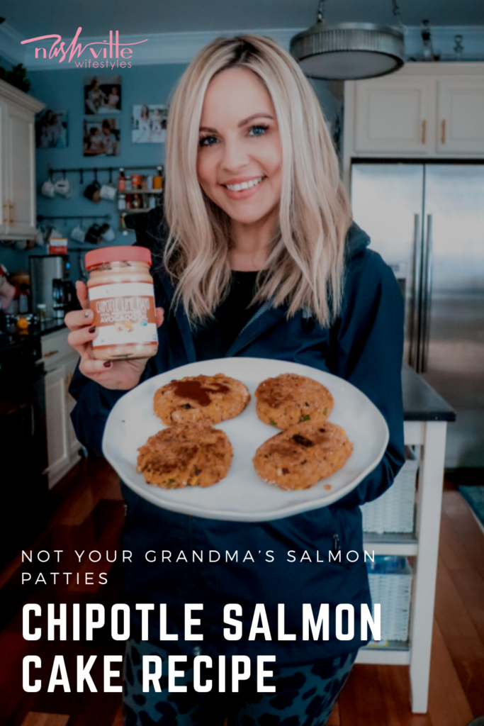 Salmon Cake Recipe by popular Nashville lifestyle blog, Nashville Wifestyles: image of woman holding cooked salmon cakes on a glass plate and a jar of Primal Kitchen Chipotle Mayo.