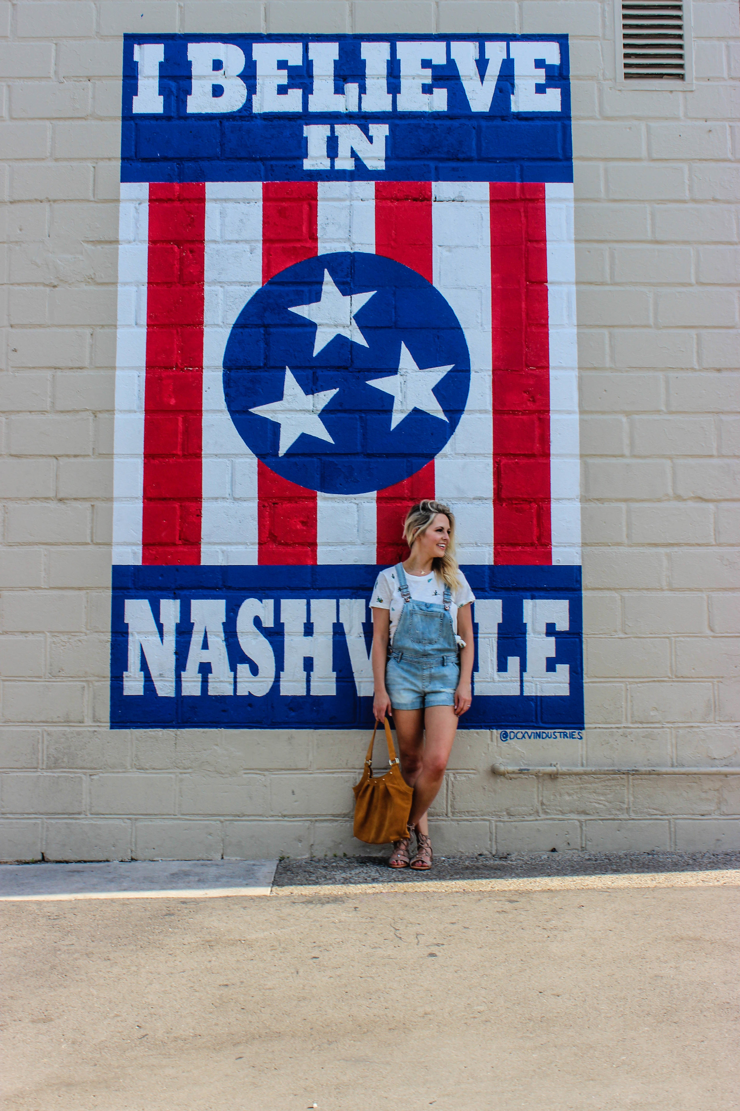 Nashville Tornadoes: How to Help the Victims & the City Of Nashville: info featured by top Nashville blog, Nashville Wifestyles. | Tornado Victims by popular Nashville lifestyle blog, Nashville wifestyles: image of a woman standing in front of a Nashville wall mural.