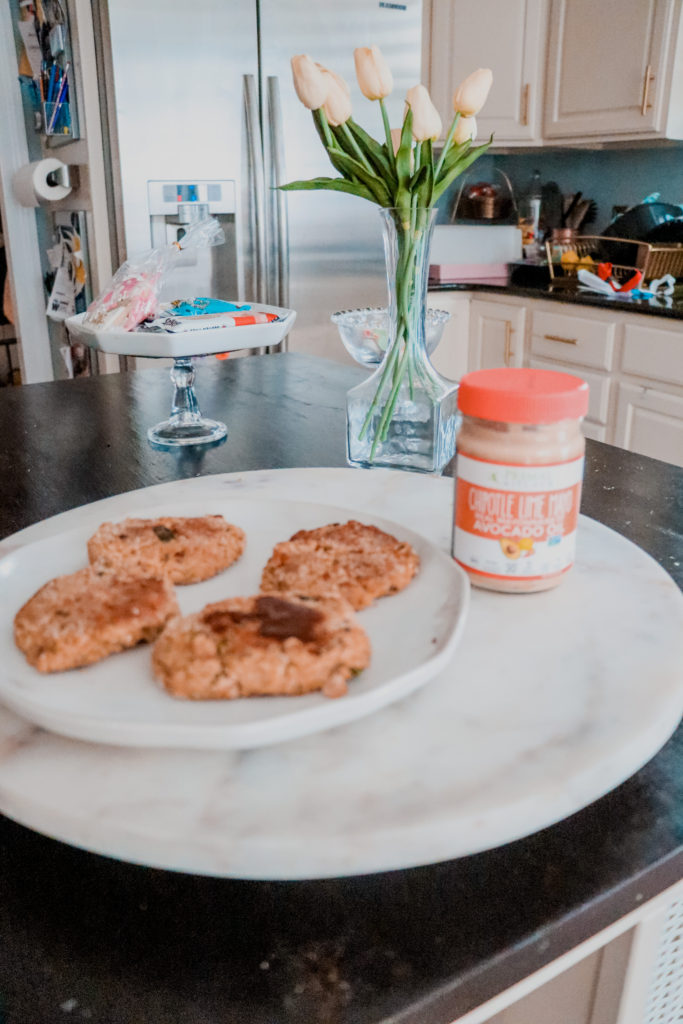 Salmon Cake Recipe by popular Nashville lifestyle blog, Nashville Wifestyles: image of cooked salmon cakes next to a jar of Primal Kitchen Chipotle Mayo.