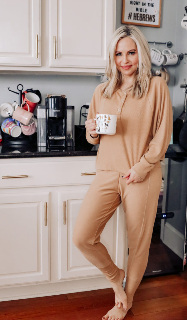 Best Loungewear by popular Nashville fashion blog, Nashville Wifestyles: image of a woman standing in her kitchen next to her coffer maker and wearing a matching loungewear set. 