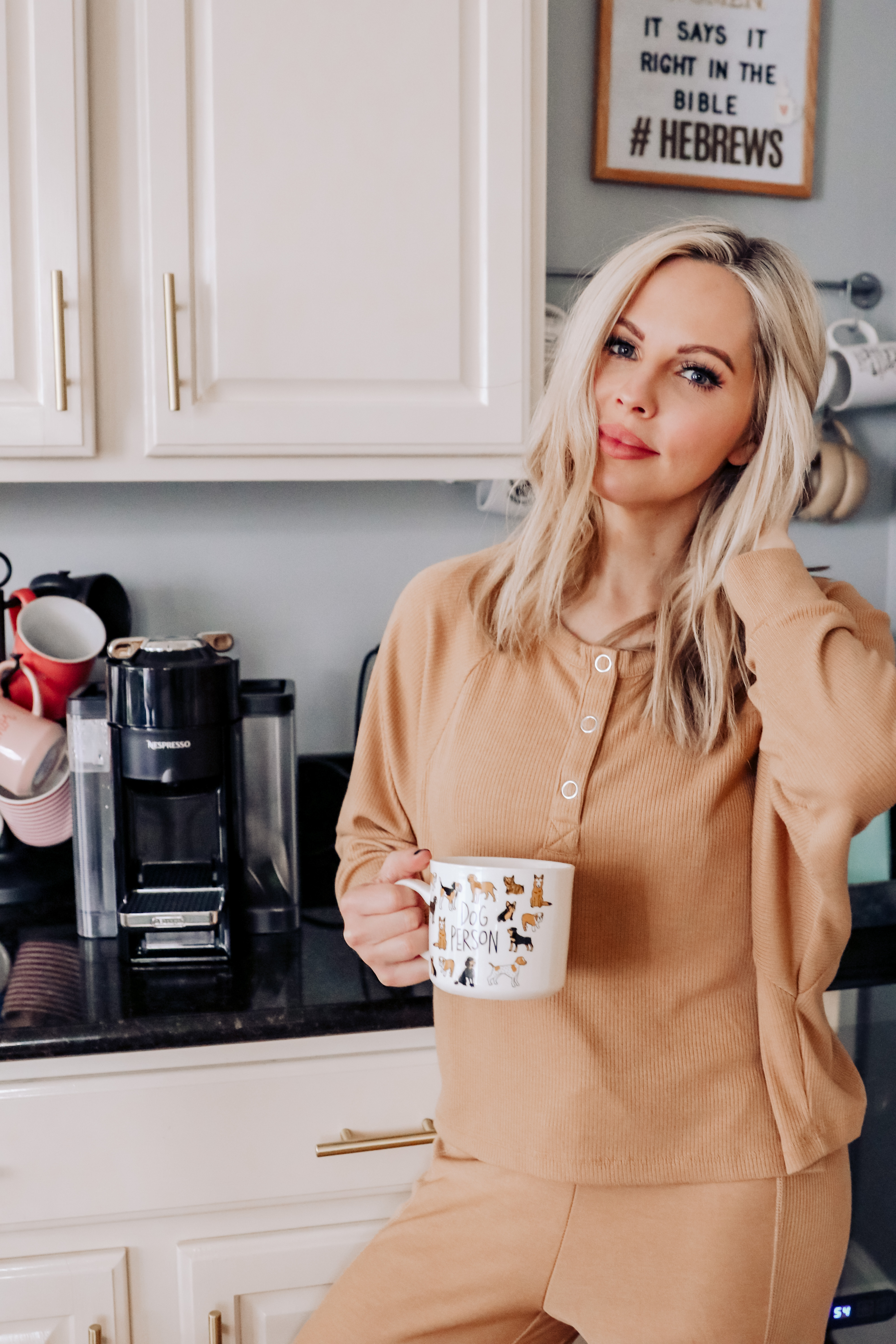 Best Loungewear by popular Nashville fashion blog, Nashville Wifestyles: image of a woman standing in her kitchen next to her coffer maker and wearing a matching loungewear set.