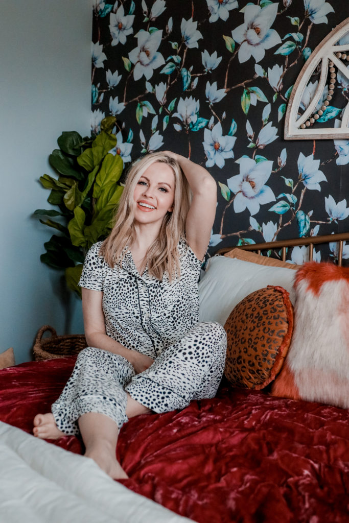 Best Loungewear by popular Nashville fashion blog, Nashville Wifestyles: image of a woman sitting on a bed and wearing leopard print pajamas. 