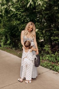 Coping Skills for Kids by popular Nashville motherhood blog, Nashville Wifestyles: image of a mom wearing a black and white jumpsuit while standing next to her daughter outside who is wearing a black and white polka dot romper.