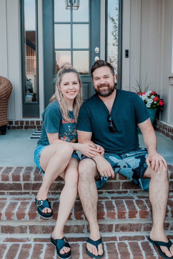 Date Night In Ideas by popular Nashville lifestyle blog, Nashville Wifestyles: image of a man and woman sitting together on their front porch. 