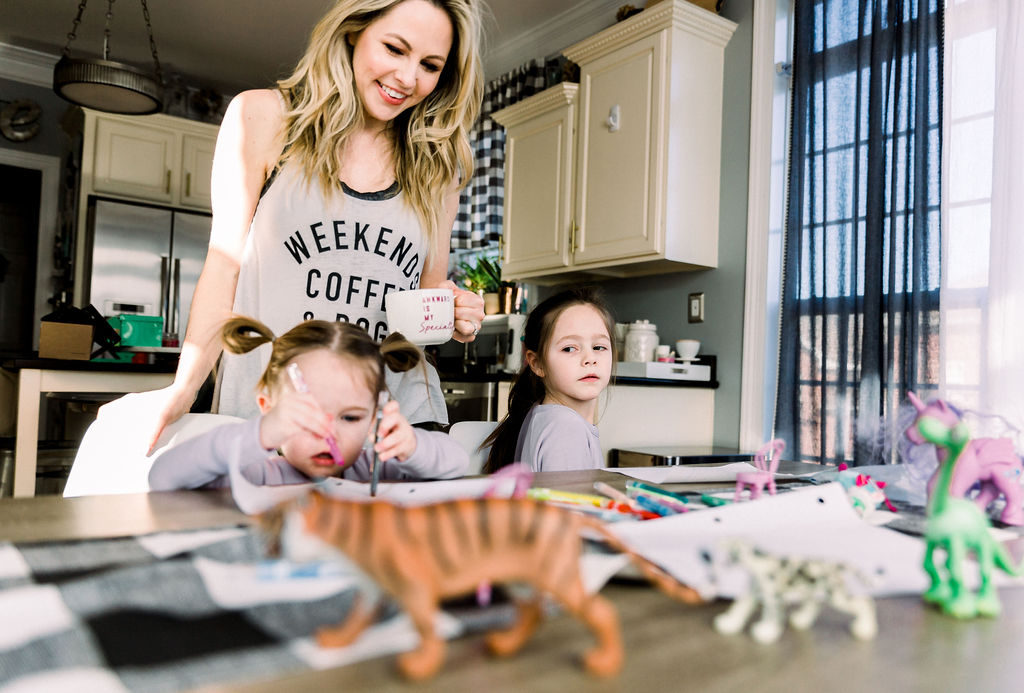 Homemade Mothers Day Gifts From Child by popular Nashville lifestyle blog, Nashville Wifestyles: image of a mom sitting at a farmhouse table with her two daughters while they work on some crafts. 