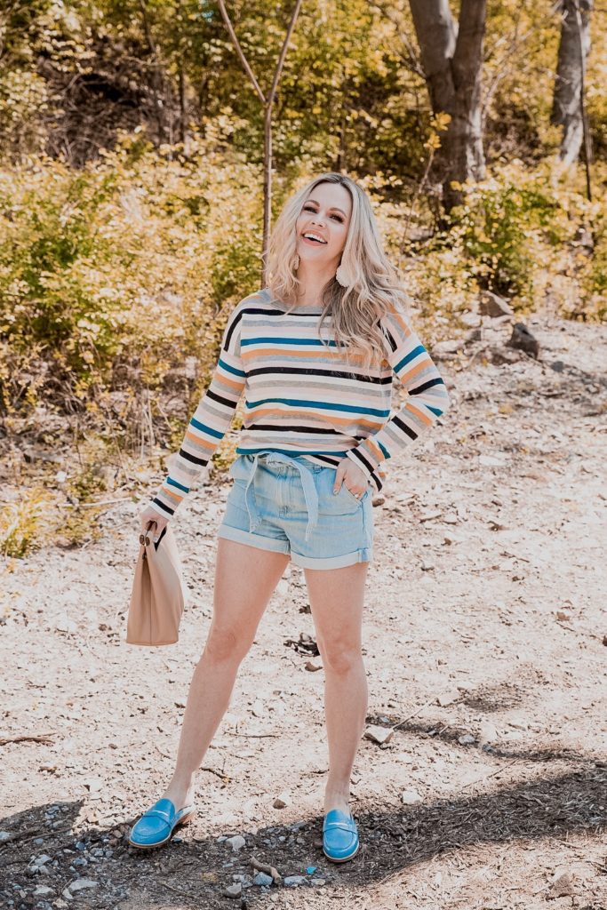 Denim Outfits by popular Nashville fashion blog, Nashville Wifestyles: image of a woman wearing denim shorts and a stripe long sleeve shirt. 