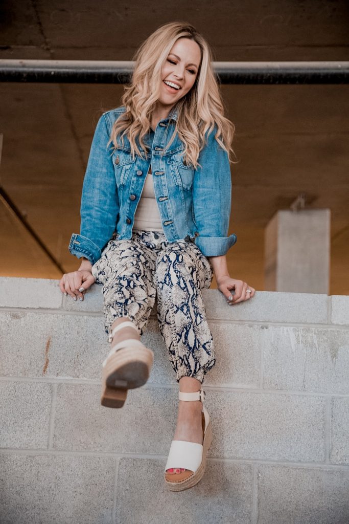 Denim Outfits by popular Nashville fashion blog, Nashville Wifestyles: image of a woman wearing a denim jacket and snake print pants. 
