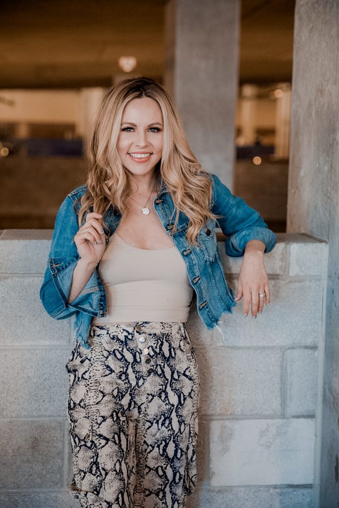 Denim Outfits by popular Nashville fashion blog, Nashville Wifestyles: image of a woman wearing a denim jacket, tan top and snake print pants.  