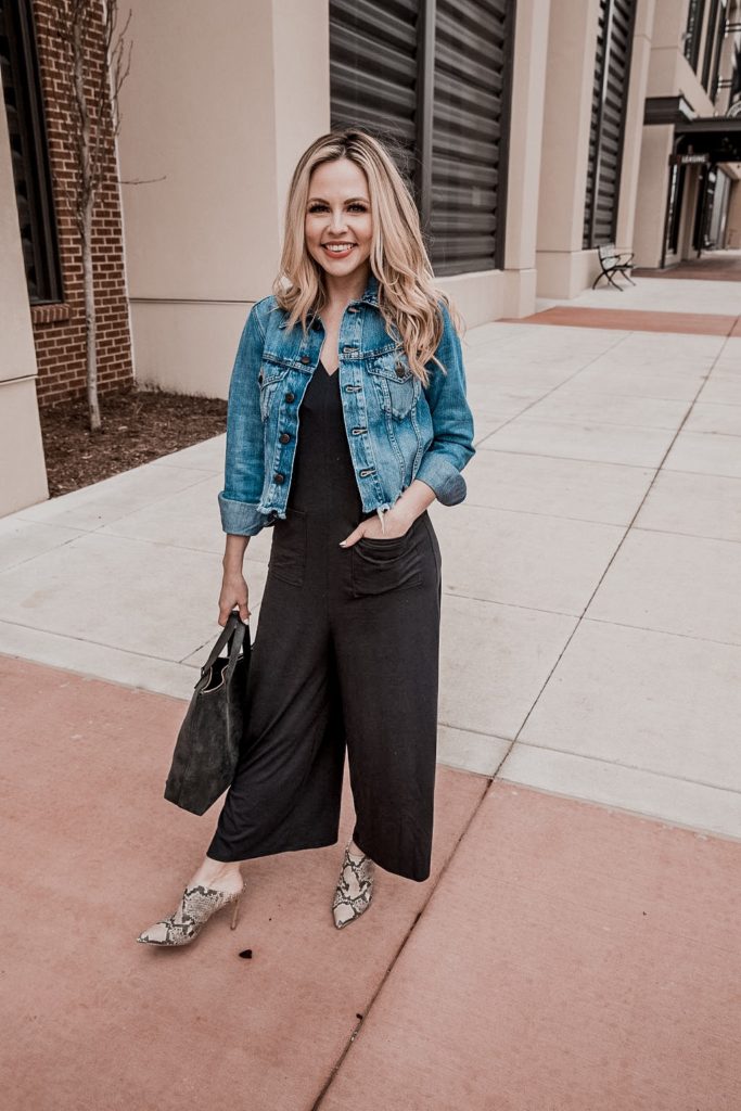Denim Outfits by popular Nashville fashion blog, Nashville Wifestyles: image of a woman wearing a denim jacket and black jumpsuit. 