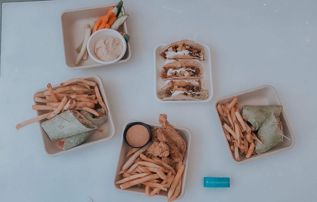 Soundwaves Water Park by popular Nashville blog, Nashville Wifestyles: image of tacos, chicken wraps, french fries, cucumber slices and carrot sticks. 