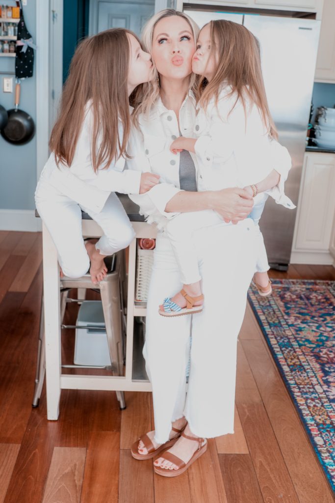 Wearing White by popular Nashville fashion blog, Nashville Wifestyles: image of a mom and her two daughters wearing matching white denim jackets and white denim jeans. 