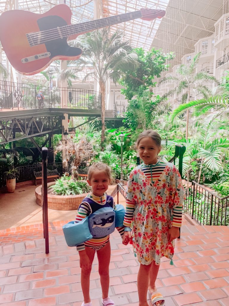 Soundwaves Water Park by popular Nashville blog, Nashville Wifestyles: image of two little girls standing in front of a hanging electric guitar. 