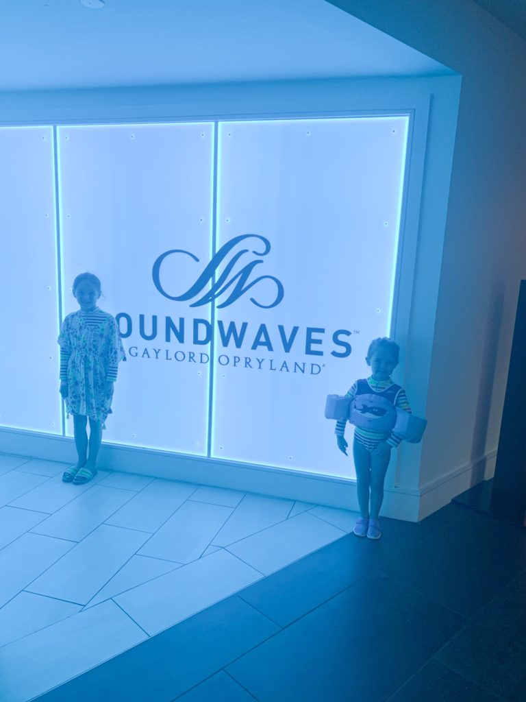 Soundwaves Water Park by popular Nashville blog, Nashville Wifestyles: image of two little girls standing in front of a Soundwaves sign. 