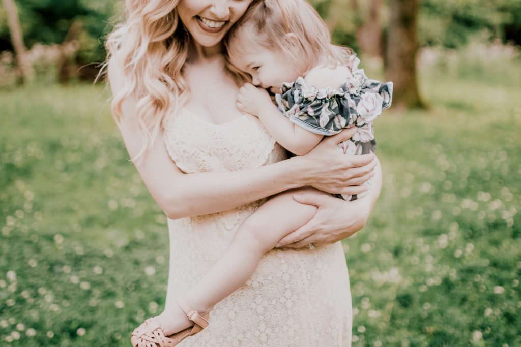 Acts of Kindness by popular Nashville motherhood blog, Nashville Wifestyles: image of mom standing outside and holding her young daughter on her hip. 
