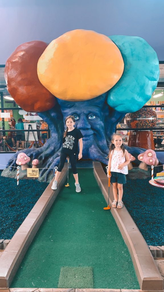 Pigeon Forge TN by popular Nashville travel blog, Nashville Wifestyles: image of a family golfing at Crave Golf. 