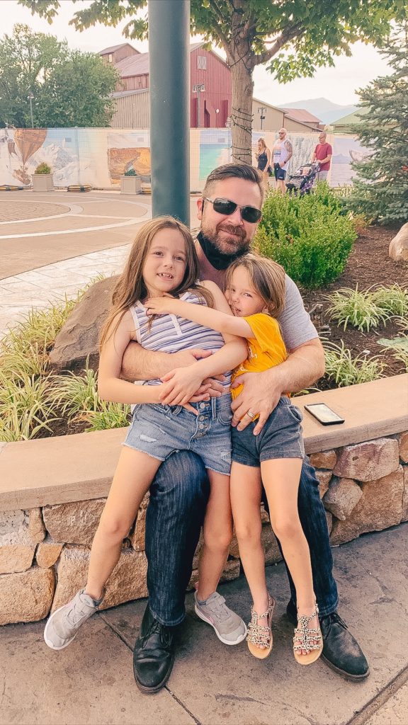 Pigeon Forge TN by popular Nashville travel blog, Nashville Wifestyles: image of a dad sitting with his two young daughters. 