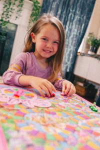 Family Board Games by popular Nashville motherhood blog, Nashville Wifestyles: image of a girl playing Candyland.