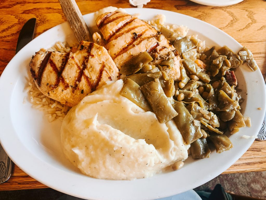 Pigeon Forge TN by popular Nashville travel blog, Nashville Wifestyles: image of a plate of chicken, mashed potatoes and gravy, and green beans. 