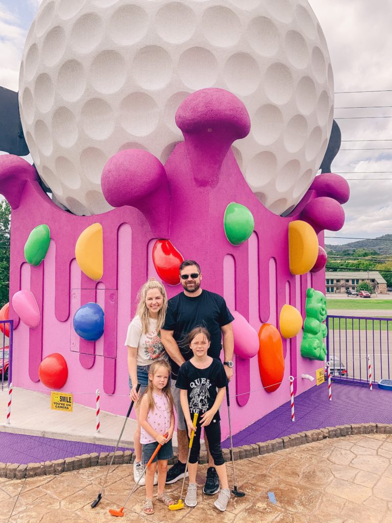 Pigeon Forge TN by popular Nashville travel blog, Nashville Wifestyles: image of a family golfing at Crave Golf. 