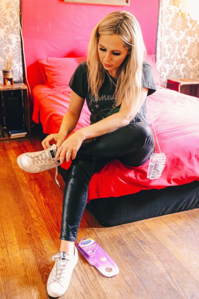 How to Relieve Sore Feet by popular Nashville lifestyle blog, Nashville Wifestyles: image of a woman putting on a pair of sneakers. 