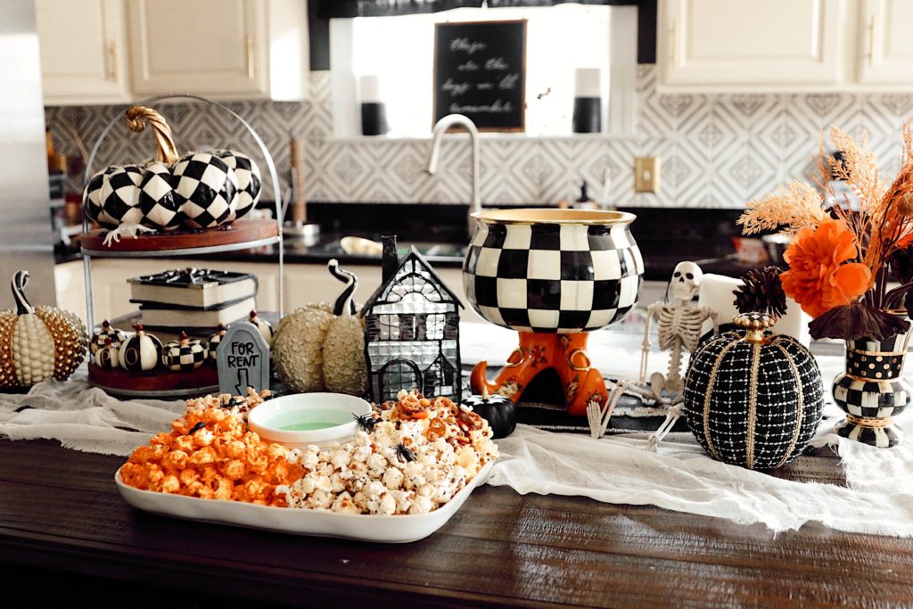 Halloween Snack Ideas by popular Nashville lifestyle blog, Nashville Wifestyles: image of a kitchen counter decorated with Mackenzie Childs Halloween decor and a serving tray filled with popcorn. 