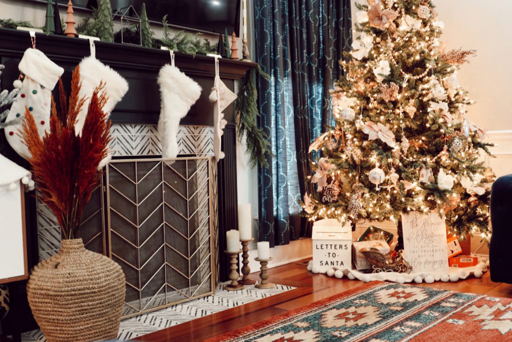 HVAC Maintenance by popular Nashville lifestyle blog, Nashville Wifestyles: image of a living room decorated with a Christmas tree, stockings, Christmas garland and Christmas tree decor. 