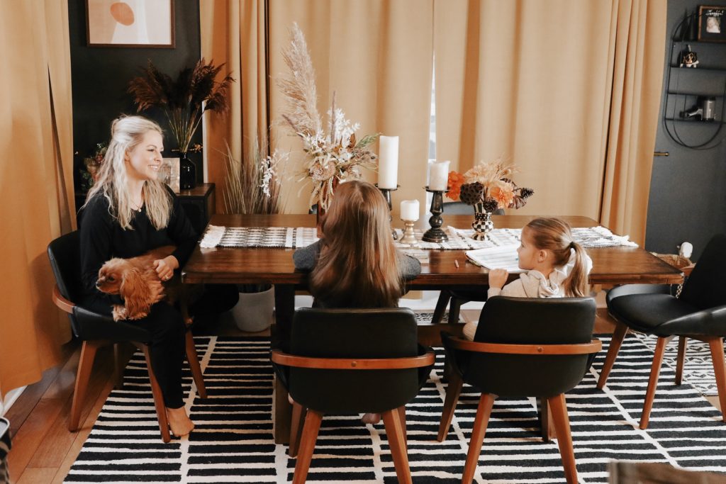Hoffmann Brothers Home Protection Plan by popular Nashville lifestyle blog, Nashville Wifestyles: image of a mom and her two young daughters sitting together at their dinning room table. 