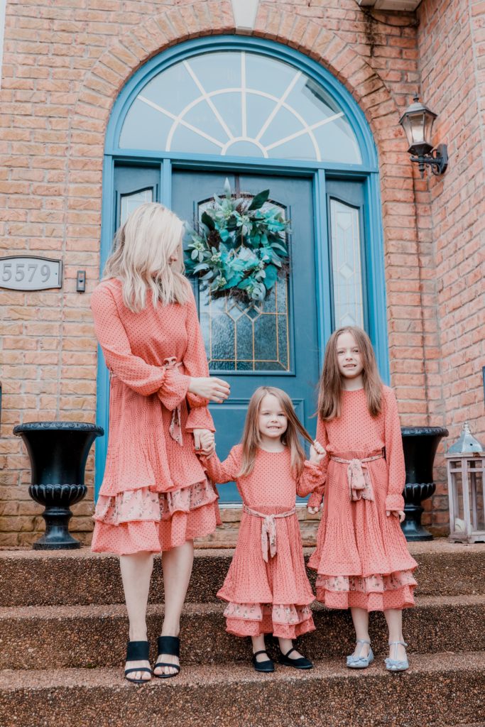 Hoffmann Brothers Home Protection Plan by popular Nashville lifestyle blog, Nashville Wifestyles: image of a mom and her two young daughters wearing matching pink polka dot and floral print dresses. 