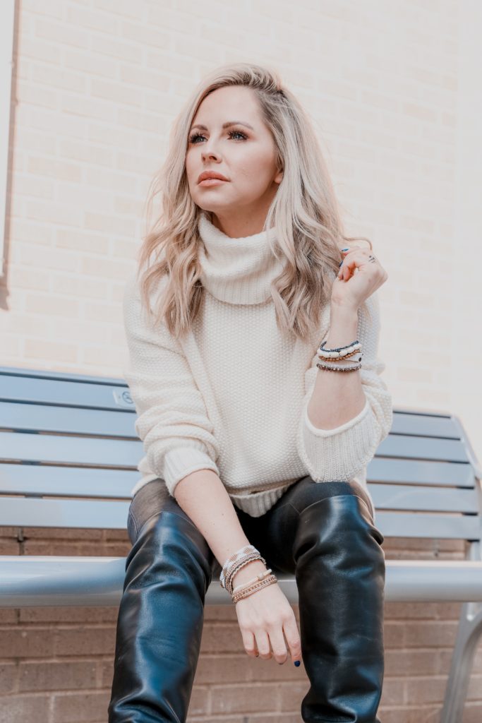 LTK Spring Sale by popular Nashville life and style blog, Nashville Wifestyles: image of a woman wearing a cream knit turtle neck sweater, black leggings, and black knee high 